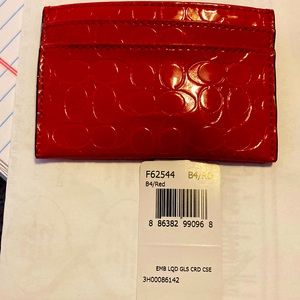 New Coach coach red embossed liquid glass credit card holder.